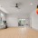 a large room with wood flooring and exercise equipment