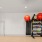 exercise equipment in a room with hardwood floors and large mirros